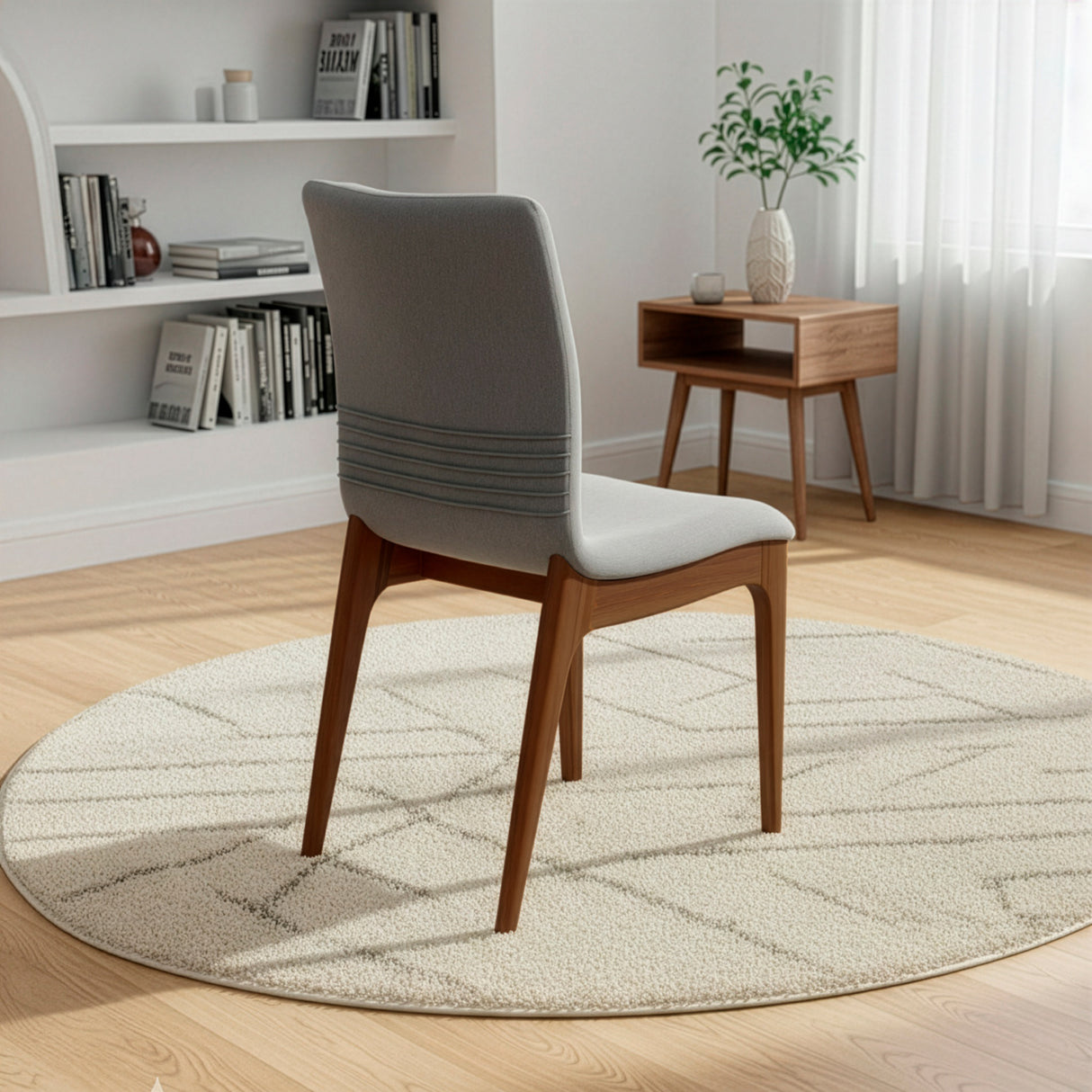 Silla acolchada con patas de madera en color gris oscuro.