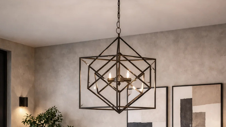 Lámpara colgante geométrica de metal oscuro sobre mesa de comedor moderno y luminoso