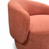 Poltrona giratoria color rojo salmón de tejido grueso