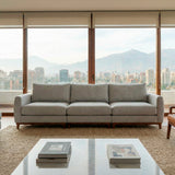 Sofá de tres cuerpos en tela lino color gris.