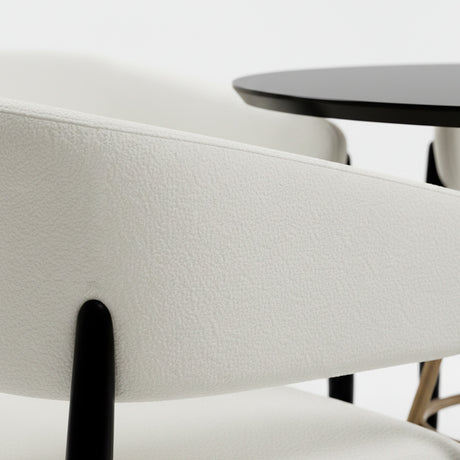 Set de mesa de comedor circular color negro con juego de cuatro sillas color blanco.