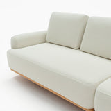 Sofá de dos cuerpos con pouf del lado derecho y mesa de madera 