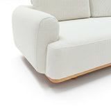 Sofá de dos cuerpos con pouf del lado derecho y mesa de madera 